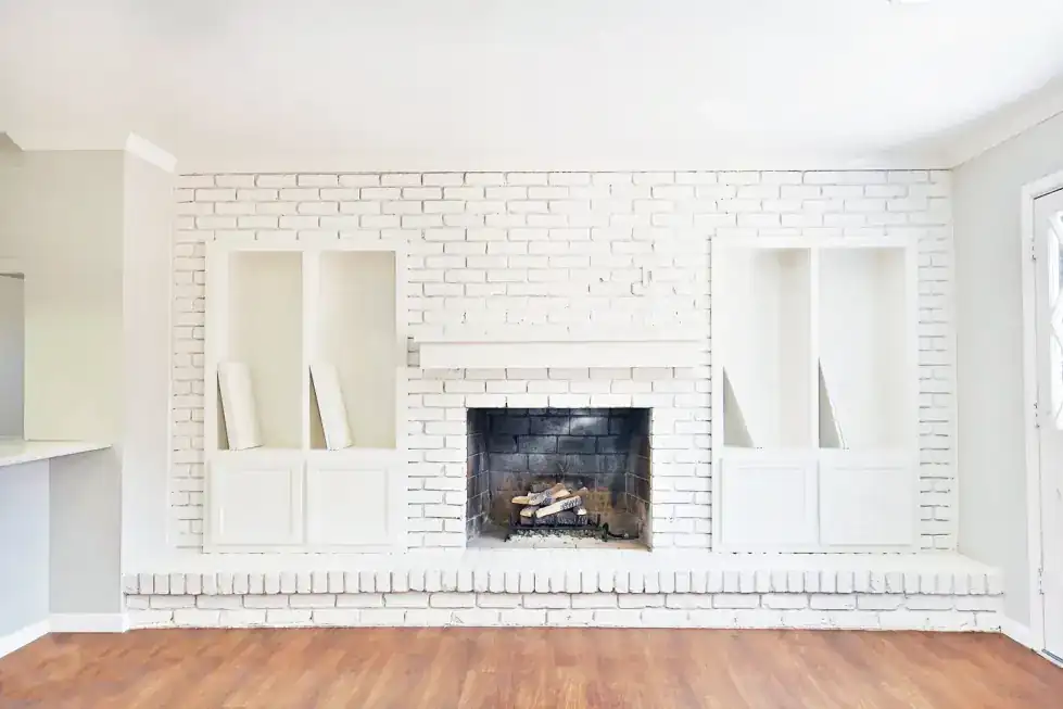 Brentwood Ranch living room with a white brick fireplace and built-in shelving
