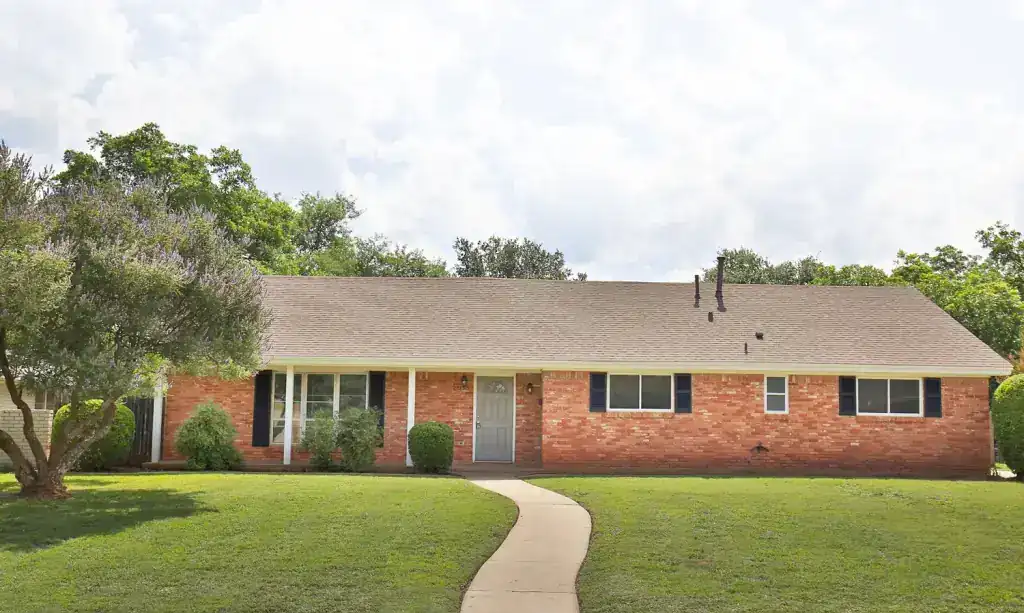 Brentwood Ranch, a long brick ranch house with a curved front walk across the lawn