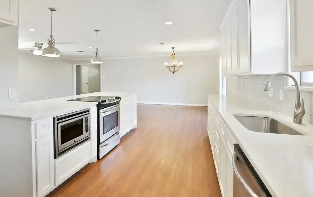 Brentwood Ranch range wall with a stainless range and white cabinets