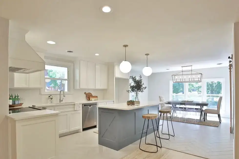Elmwood's open kitchen and dining room with a gray island and globe pendants