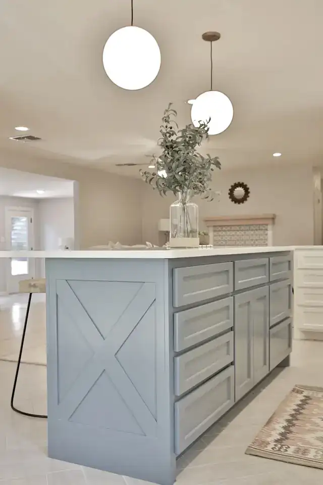 Close view of the Elmwood kitchen island, a gray base with an X brace under a white top