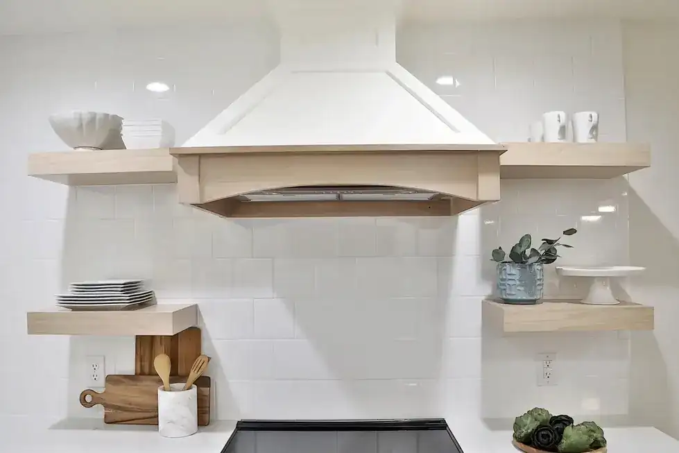 Green Acres range hood with floating shelves beside it