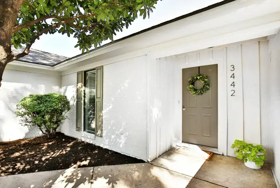 High Meadows entry with board-and-batten siding and a covered front porch